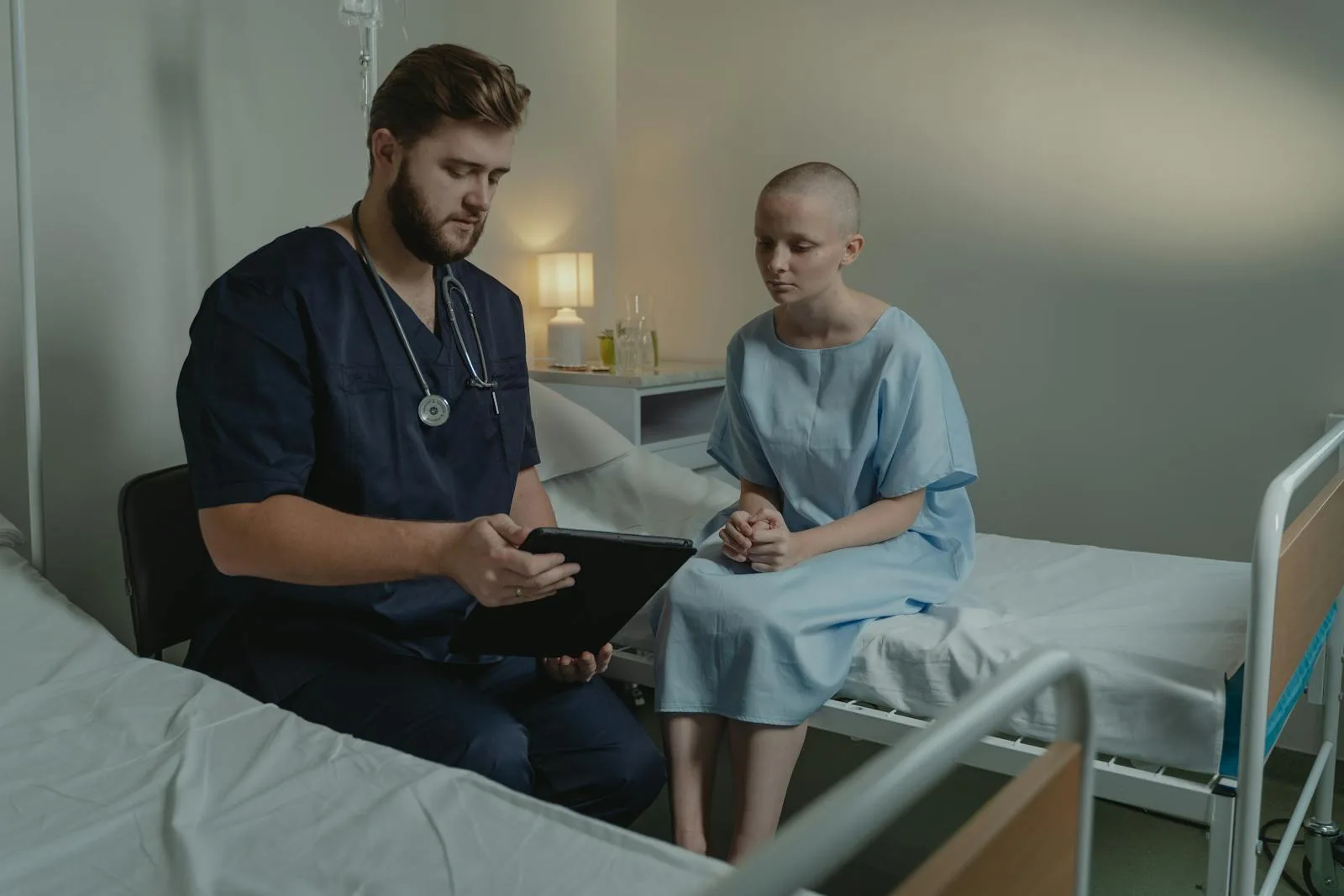 A hospital care team conferring at the bedside over a patient's recovery findings.