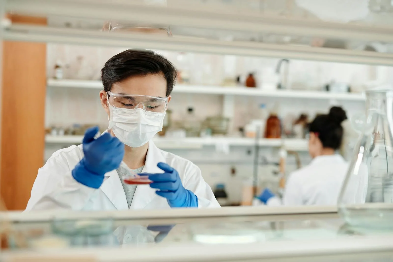 A research scientist working in a modern laboratory, where real-world evidence is generated.